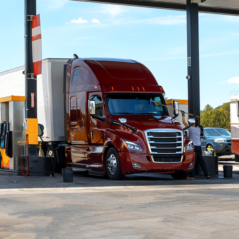 a semi truck fueling up at a gas station