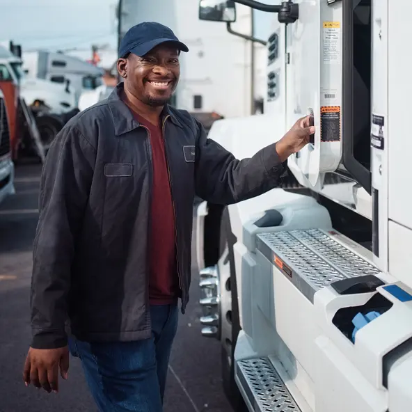 smiling trucker next to truck