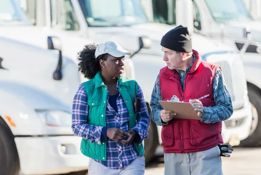 Two truck drivers talking. 