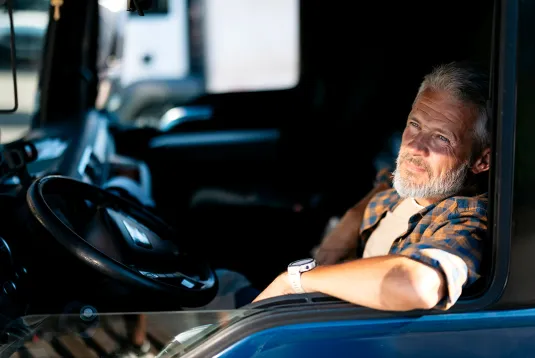 Truck driver looking out a window. 
