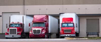trucks waiting at loading dock bg