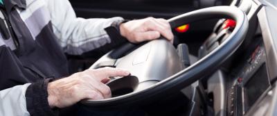 Driver with hands on wheel