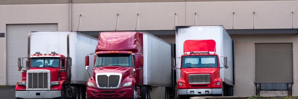 trucks waiting at loading dock bg